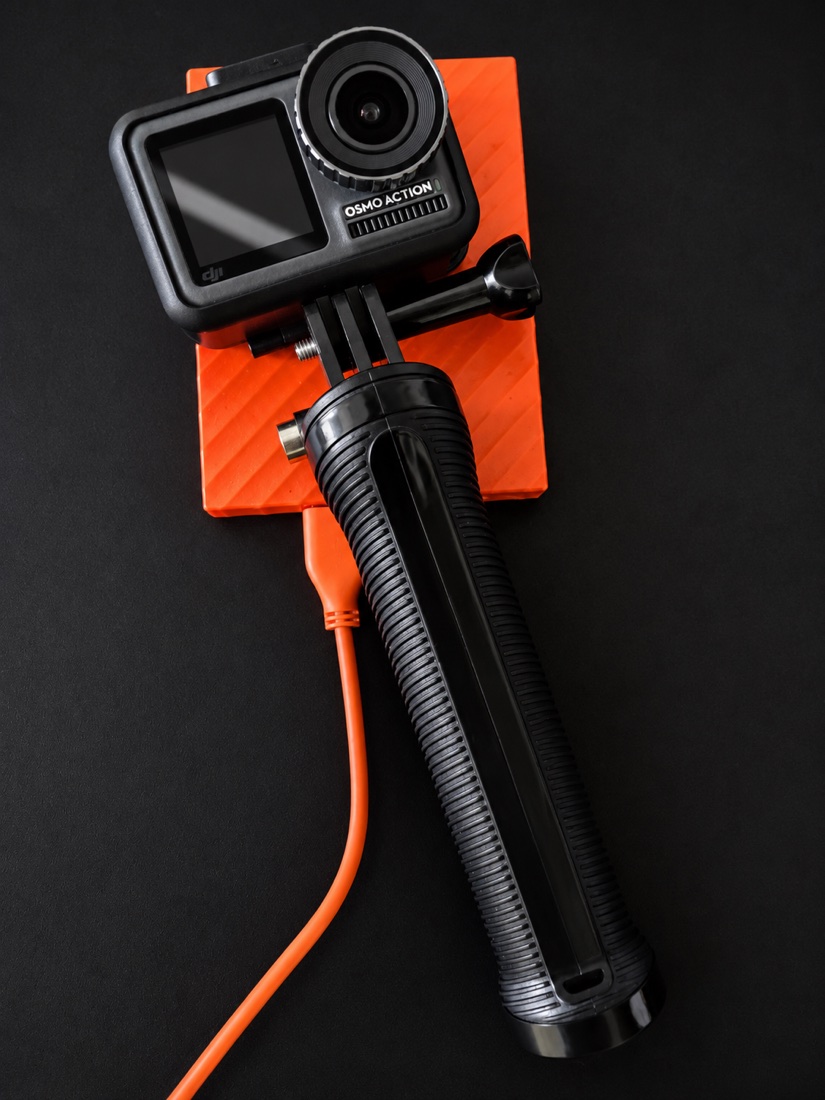 A DJI Osmo Action camera mounted on a grip