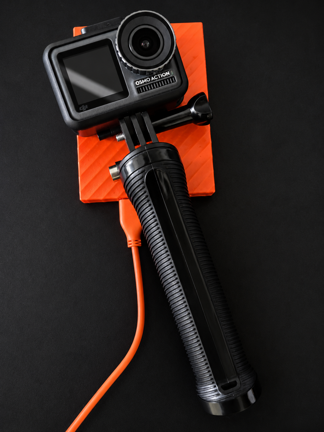 A DJI Osmo Action camera mounted on a grip