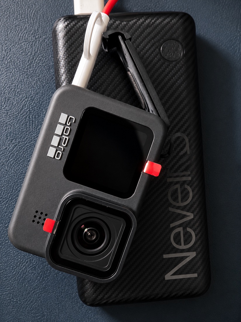 A GoPro action camera resting on a carbon-fibre power bank