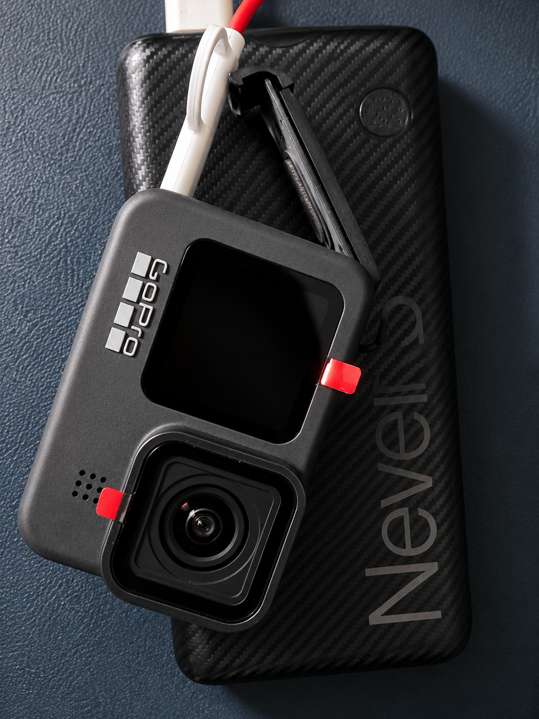 A GoPro action camera resting on a carbon-fibre power bank