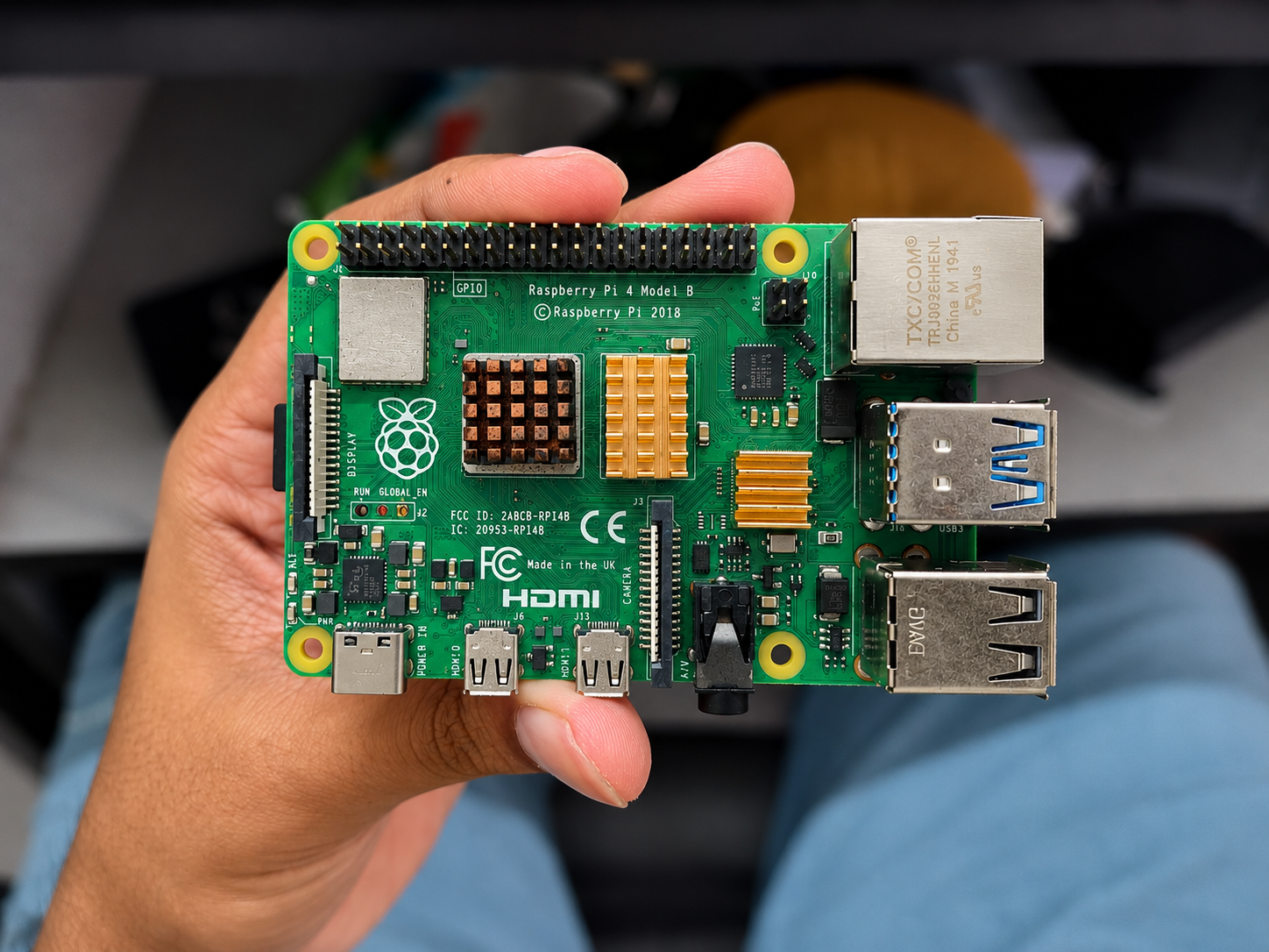 A Raspberry Pi 4 Model B held in one hand